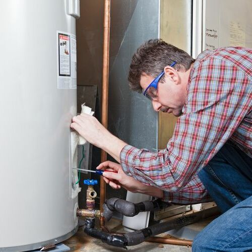 A Plumber Installs a Water Heater.