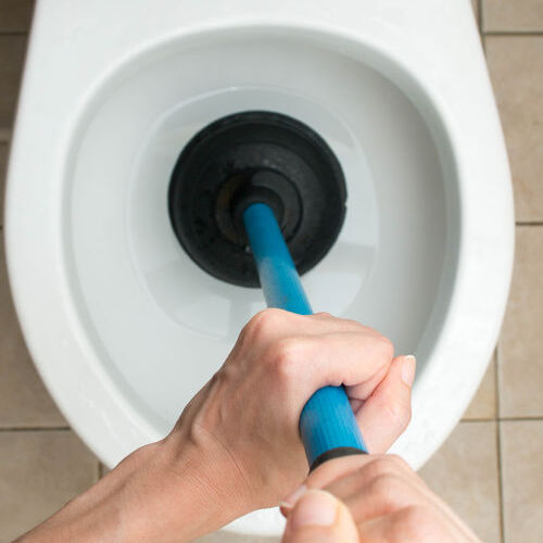 Plumber Uses Plunger for Toilet Unclog.