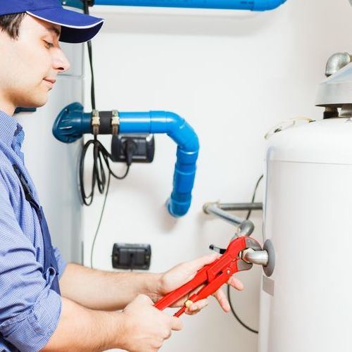 A Plumber Works in a Water Heater.